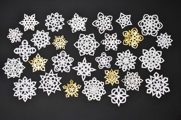 paper snowflakes on a black background