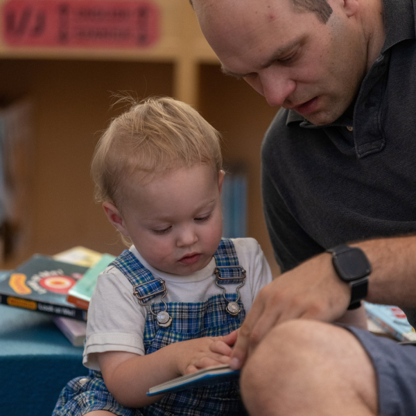 father reads to toddler