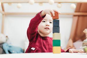 toddler stacks wooden blocks