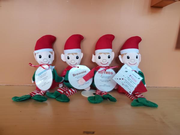 four stuffed elves