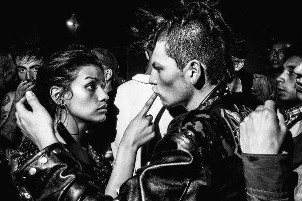 B&W photo of Couple wearing leather jackets facing one another