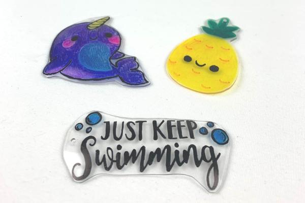 photo of a narwhal, pineapple, and "just keep swimming" shrinky dinks