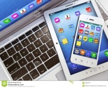 Image of a laptop, iPad, and iPhone stacked on top of each other