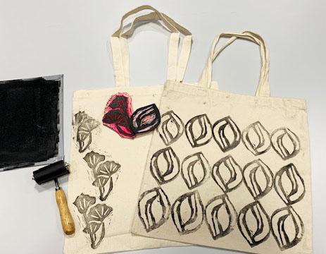 beige tote bags stamped with black ink