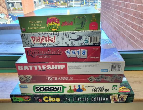 pile of board games stacked on top of one another