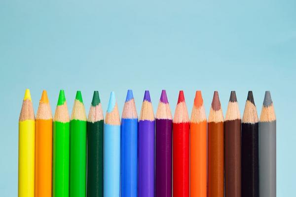 colored pencils lined up on a blue background