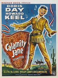 An illustration of Doris Day in a buckskin outfit, against a western landscape.