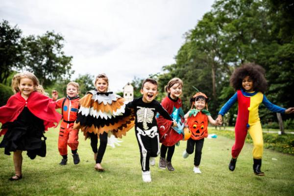 seven children dressed in Halloween costumes