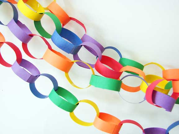Photograph of lengths of paper chains made with multiple colors of paper by Abbey Hendrickson.