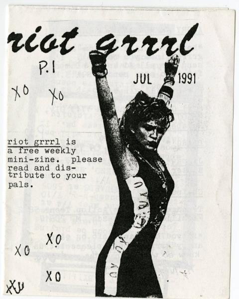 cover of an issue of Riot Grrrl; a woman standing with her arms up triumphantly