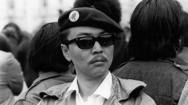 black and white image of Richard Aoki in a black beret and sunglasses