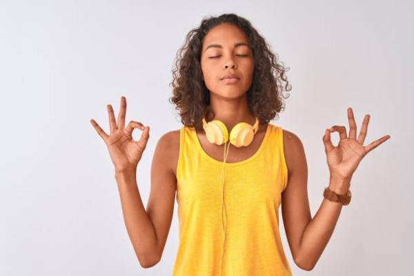 teen with eyes closed doing a yoga mudra