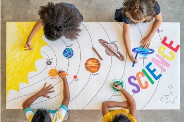 young kids drawing on a poster 